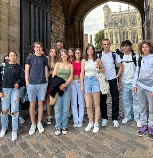 A group of teenage students on a trip to Windsor castle posing for a photo