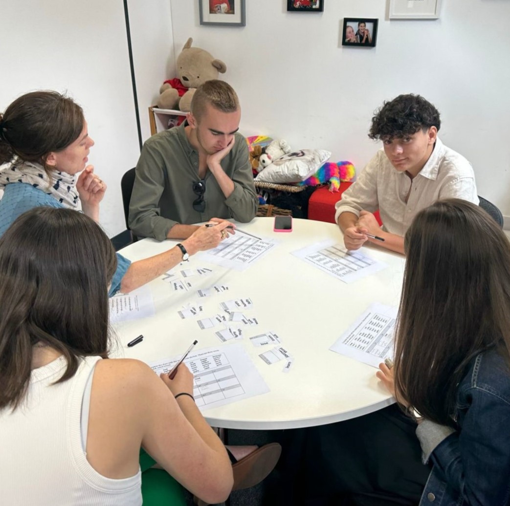 A group of students working on a round table