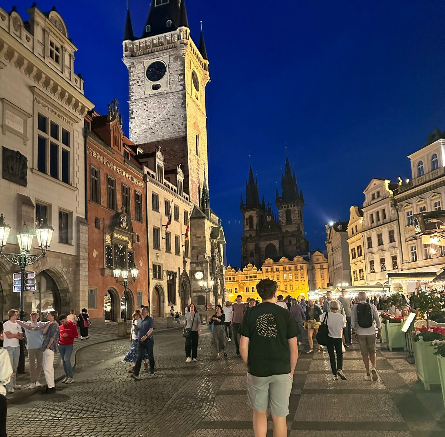 A busy high street at night in Prague