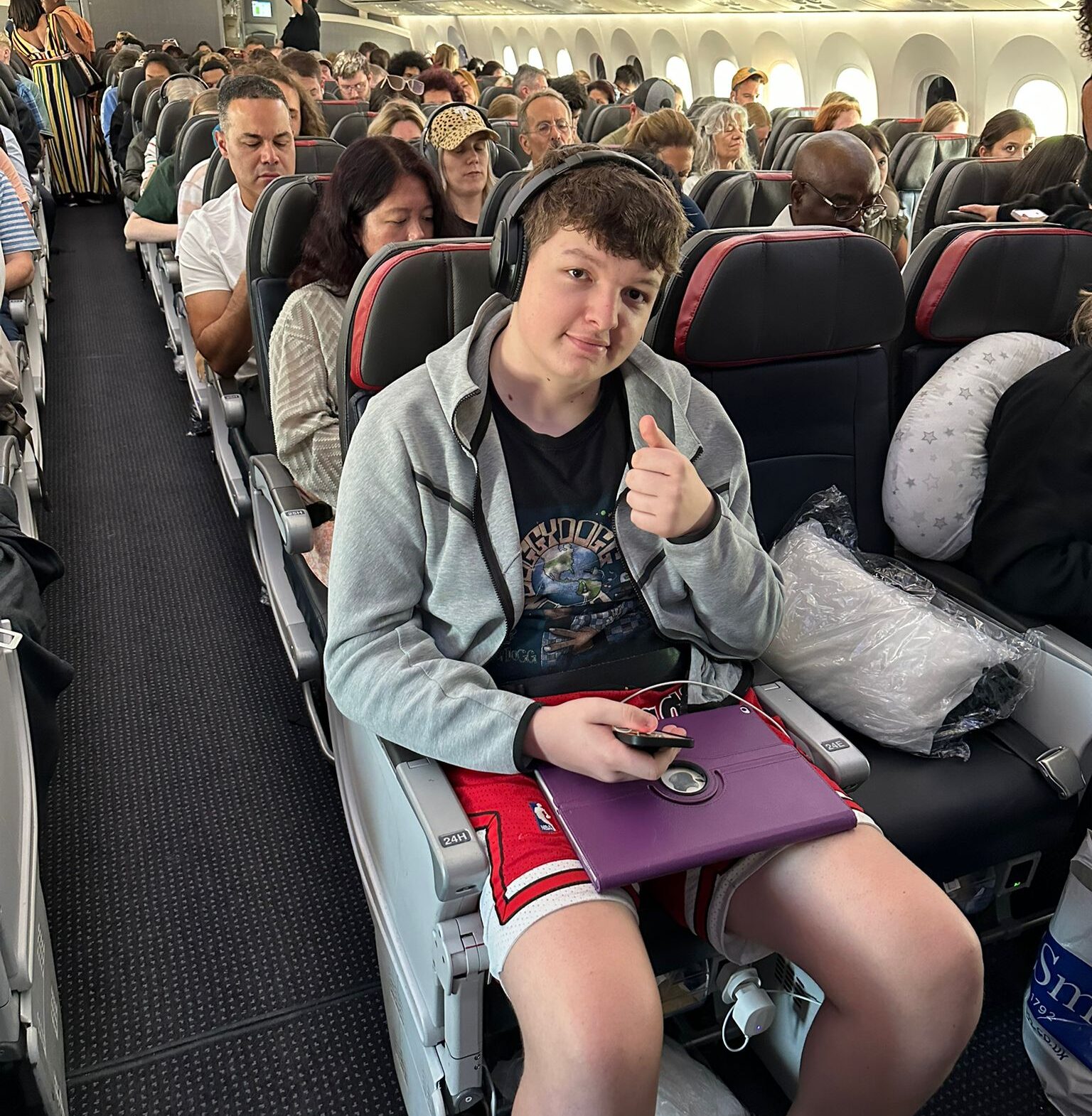 A teenage boy sat waiting for a plane to take off