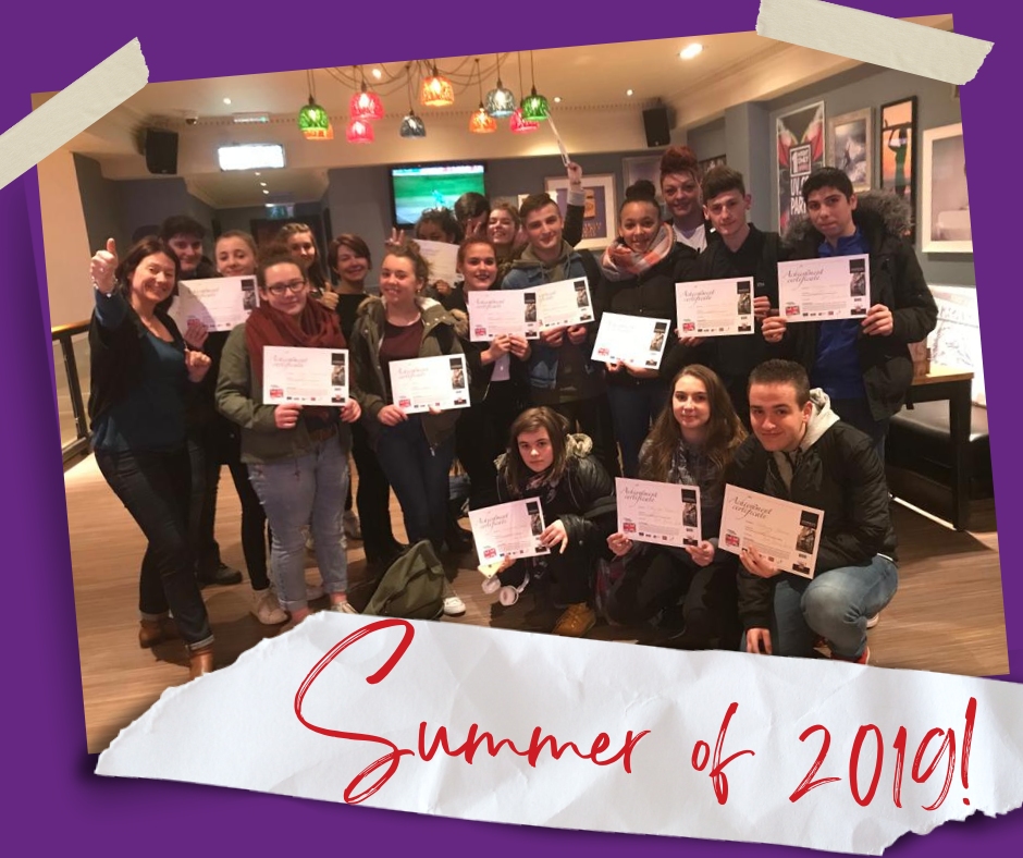 A group of students with certificates with the title 'Summer of 2019!'