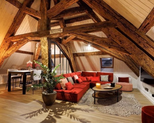 A cosy lounge room with low wooden beams