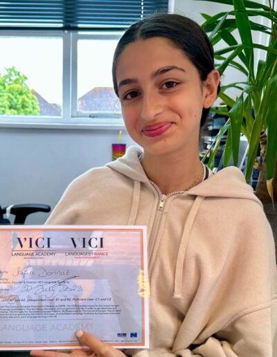 A proud female student holding a certificate