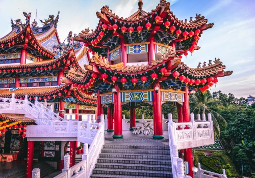 A red chinese temple with stairs leading up