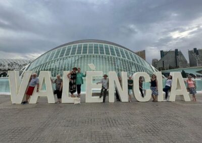 A group og people posing in front of a Valencia sign