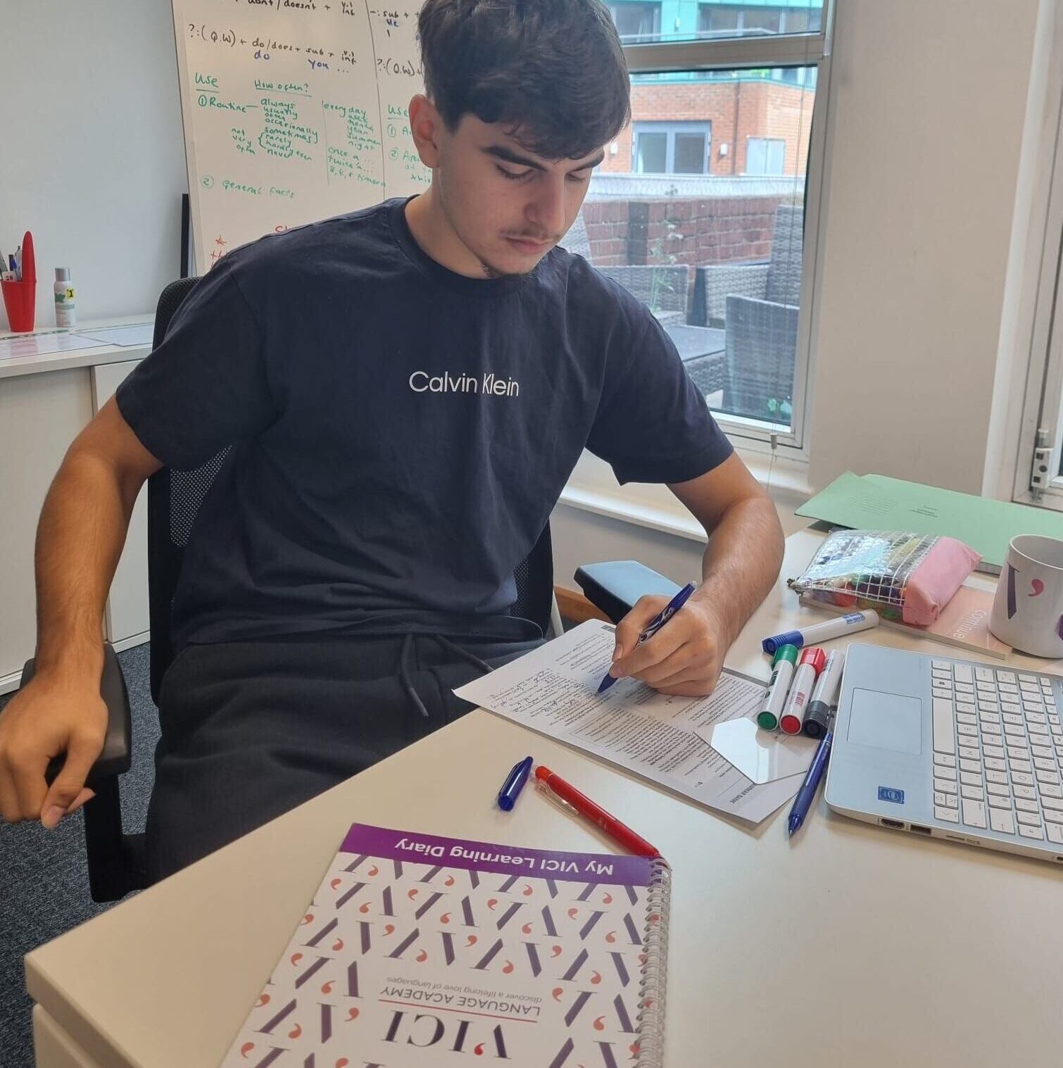 A young girl wearing a green top posing outside Windsor castle